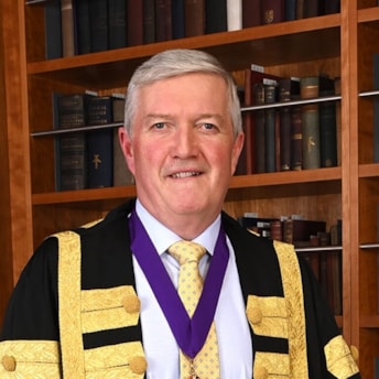 Headshot of Dr Diarmuid O'Shea in his presidential gown. Dr O'Shea is President of RCPI